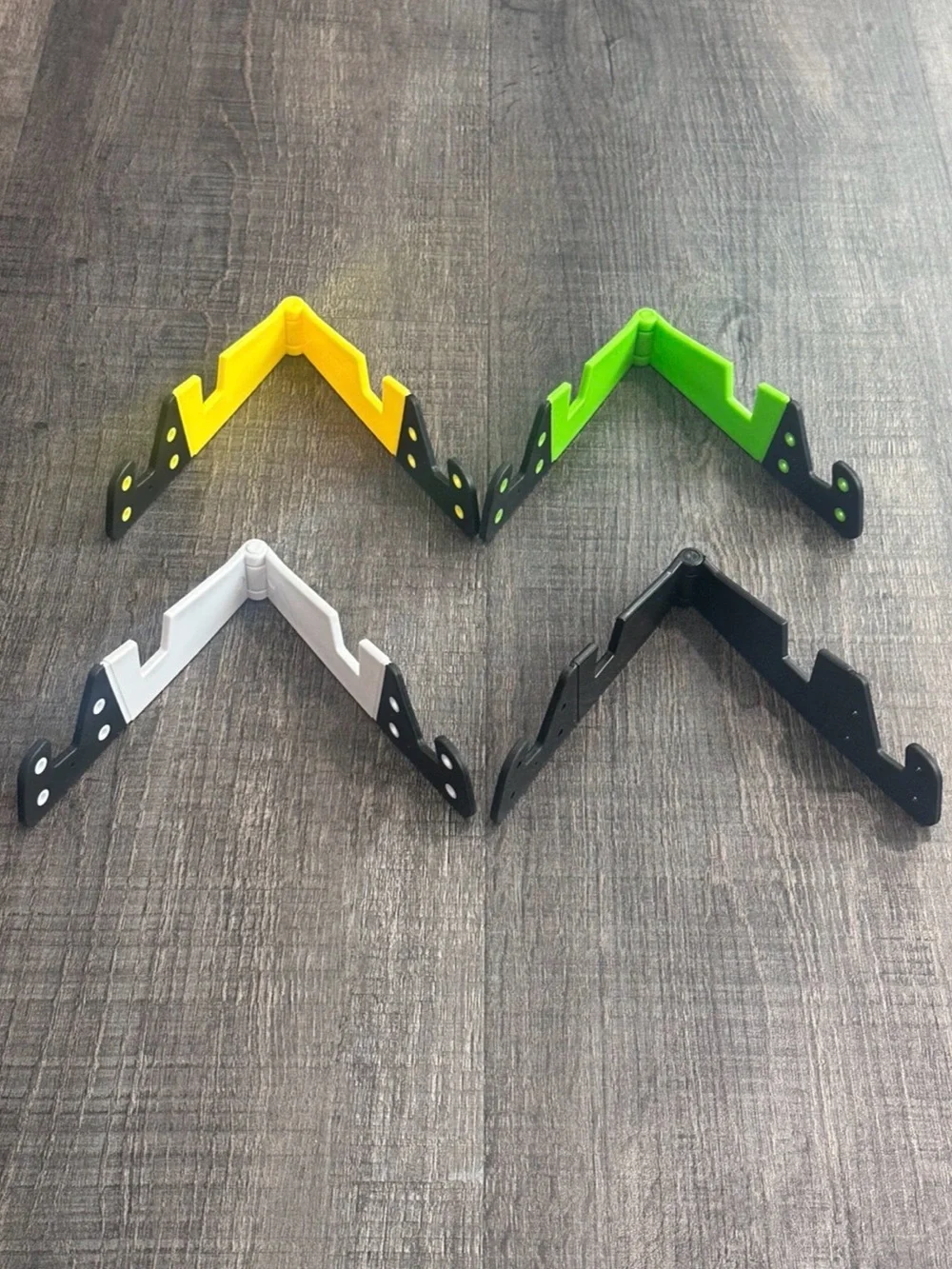 New Pack of 4 Universal Folding Phone Stands in Black, White, Yellow, & Green